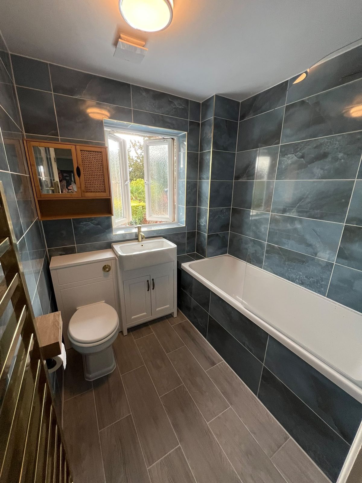 New vanity basin and back-to-wall toilet with wood-effect floor